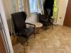 Entrance Into Day Room-2 Brown Highback Chairs, Telephone Table, Framed Photo, Round Top Table, - Wicker Stool Yellow Bin, Wall Mounted Leaflet Holder - 2