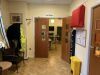 Entrance Into Day Room-2 Brown Highback Chairs, Telephone Table, Framed Photo, Round Top Table, - Wicker Stool Yellow Bin, Wall Mounted Leaflet Holder - 3