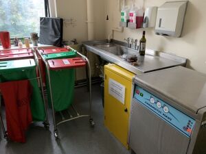 Sluice Room- 2 x Linen Trollies, 1 x Yellow Storage Press, S/S Sink, S/S Panamatic Maxi Top/Loading - Washer Disinfector, 3 Metal Disposal Bins