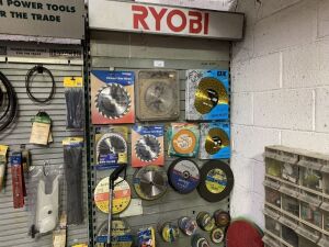 Ryobi Racking c/w Contents to Include: Large Selection of Unused Blades & Cutting Discs, Jefferson Measuring Wheel, 110v Leads & More