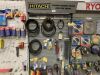 Hitachi Racking c/w Contents to Include: Selection of Machine Belts, Large Selection of 110v Plugs, Chainsaw Parts, Cable Ties, Selection of Garden Hose Fittings, Selection of Wire Brushes, Nail Fix Nails & More